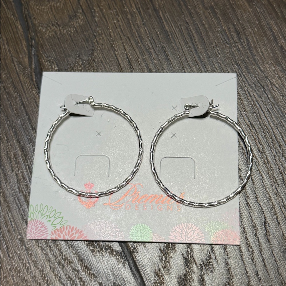 Premier Designs silver-tone hoop earrings featuring an etched, textured design